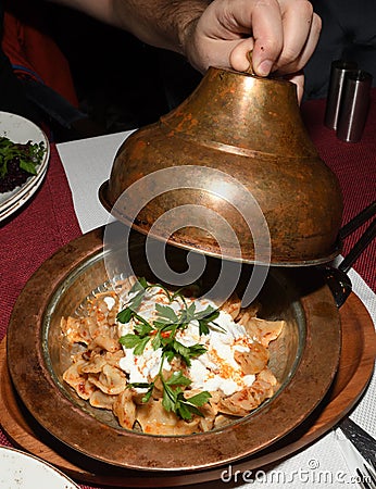 Manti is an extraordinary dish from Turkey: tiny lamb-stuffed dumplings topped with three sauces Stock Photo