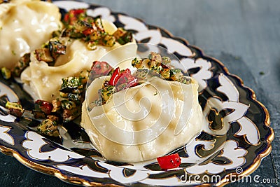 Manti, Mantu or Manty with Fried Vegetables Stock Photo