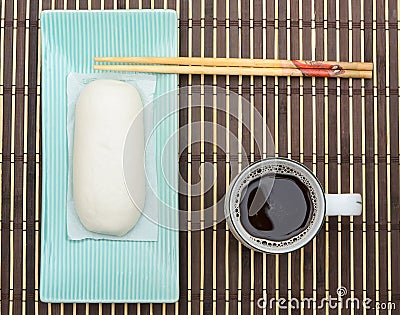 Mantou Chinese steamed bun in green dish on bamboo mat Stock Photo