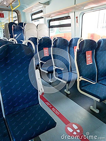 Mantova, Italy - 20th June 2020: trenitalia train with red signs on the seats that say to leave seat free Editorial Stock Photo