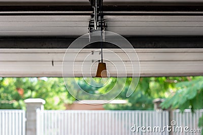 Manual cable operated garage shutter door opener inside to out view point Stock Photo