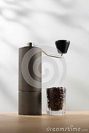 Manual coffee grinder and dark roast coffee beans Stock Photo