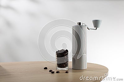 Manual coffee grinder and dark roast coffee beans Stock Photo