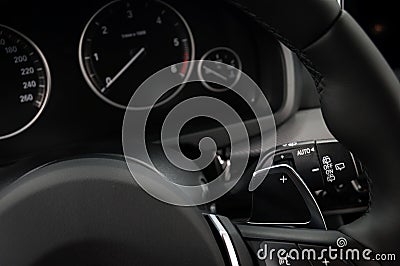 Manual gear changing stick on a car`s steering wheel. Stock Photo