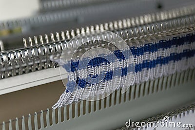 Manual knitting machine. A knitting machine is a device used to create knitted fabrics Stock Photo