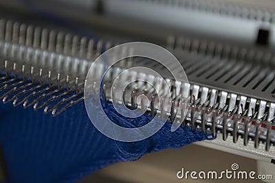 Manual knitting machine. A knitting machine is a device used to create knitted fabrics Stock Photo