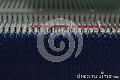 Manual knitting machine. A knitting machine is a device used to create knitted fabrics Stock Photo