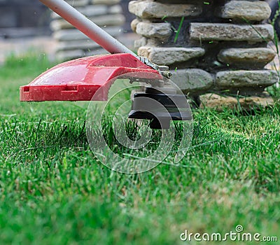 Manual lawn mower on the background of green grass Stock Photo