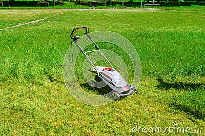 Manual lawn mower on a football field. Mowing the grass Stock Photo