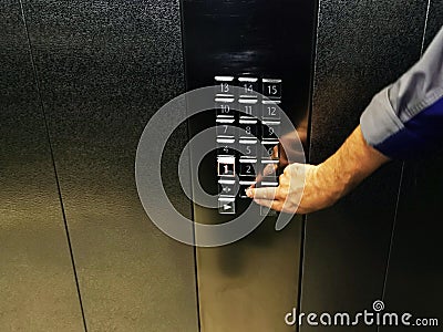 Manual pressing the elevator hold button, elevator control button panel Stock Photo