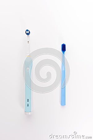 Manual Regular Toothbrush Against Modern Electric Toothbrush Stock Photo