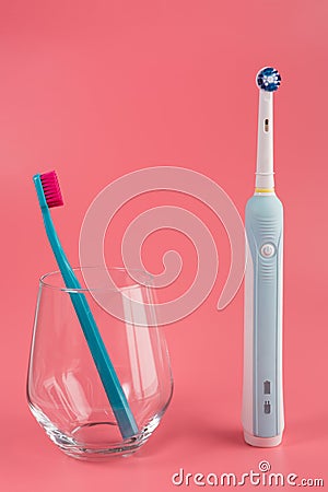 Manual Regular Toothbrush Against Modern Electric Toothbrush Stock Photo