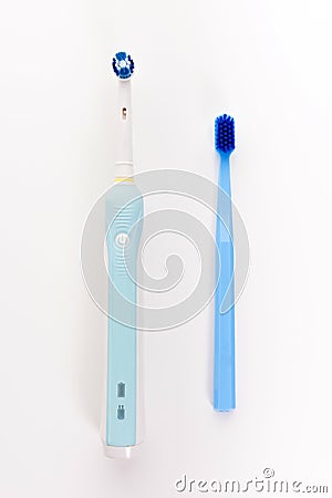 Manual Regular Toothbrush Against Modern Electric Toothbrush. Stock Photo