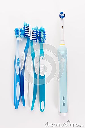 Manual Regular Toothbrush Against Modern Electric Toothbrush Stock Photo