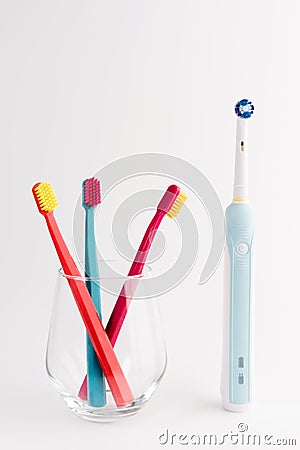 Manual Regular Toothbrush Against Modern Electric Toothbrush Stock Photo