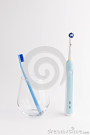 Manual Regular Toothbrush Against Modern Electric Toothbrush Stock Photo