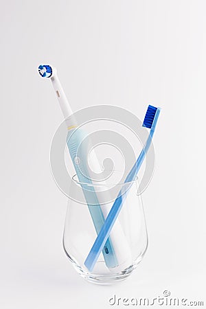 Manual Regular Toothbrush Against Modern Electric Toothbrush. Stock Photo