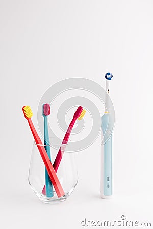 Manual Regular Toothbrush Against Modern Electric Toothbrush Stock Photo