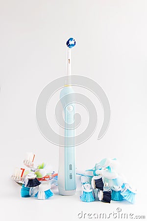 Manual regular Toothbrush Against Modern Electric Toothbrush. Stock Photo