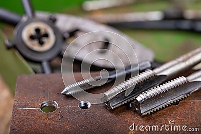 Manual thread cutting in metal. Locksmith accessories for small work in the home workshop Stock Photo