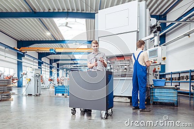 Manufacturing workers on the factory floor being industrious Stock Photo
