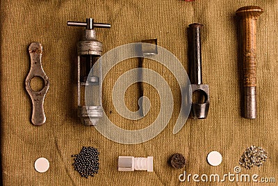 Many accessories for reloading hunting cartridges lie on the old Stock Photo