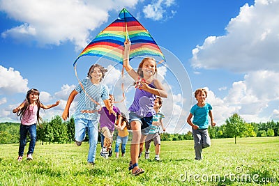 Many active kids with kite Stock Photo