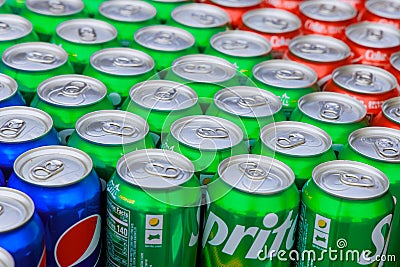 Many aluminum cans of sparkling drinks Sprite, Coca-Cola, Pepsi staying in a rows. Editorial Stock Photo