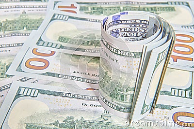 Many American Hundred Dollar Bills packed in roll Stock Photo