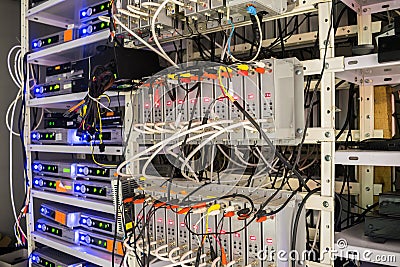 Many audio and video wires are connected to the distribution modules of the TV station. Rack with telecommunication equipment is Editorial Stock Photo