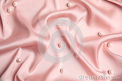 Many beautiful pearls on delicate pink silk, flat lay Stock Photo