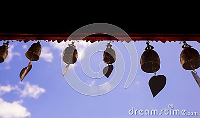 Many bell hanging against the background the blue sky Stock Photo