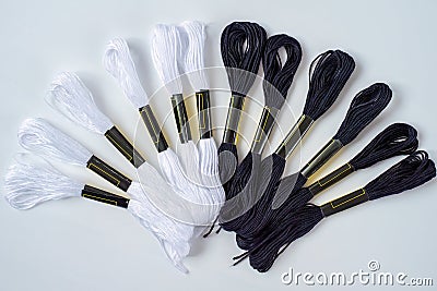 Many black and white skeins of mouline thread for embroidery on a row in circle on whitebackground Stock Photo