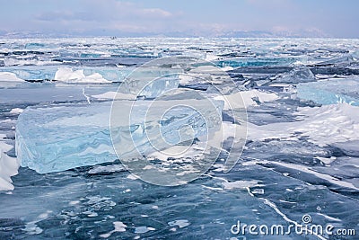 Many blue hummocks on the surface of blue frozen Lake Baikal Stock Photo