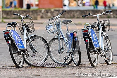 Many blue shared bikes Nextbike on Riga street parking, bicycle rental service spot on city street Editorial Stock Photo