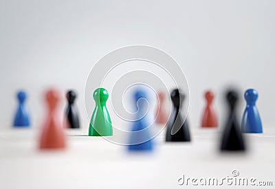 Many board game pawns on table, selective focus on the green one Stock Photo