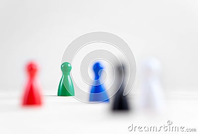 Many board game pawns on table, selective focus on the green one Stock Photo