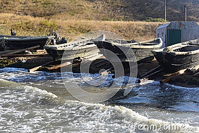 Many boats, pier, fishing mill, boat on the shore,Storm, sea foam, sea pine, wave boiling, heel wave, wave swirling, sea raging Stock Photo