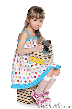 Many books or a new gadget? Stock Photo