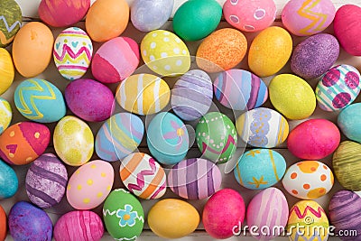 Many Bright and Colorful Easter Eggs Filling the Background. They are hand-painted or dyed. Stock Photo