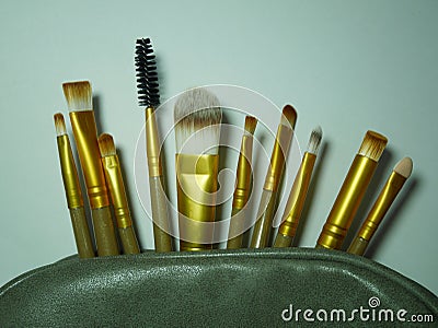 Many brown and gold makeup brushes Stock Photo