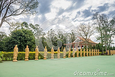 Many Buddha statues in perspective at the buddhist temple Editorial Stock Photo