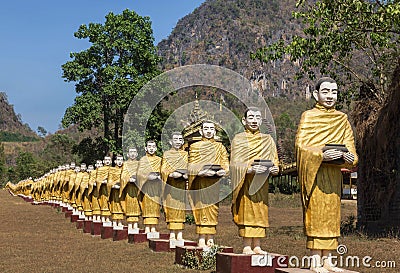 Many buddha statues standing in row at temple in Myanmar Burma Stock Photo