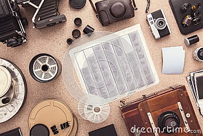 Many cameras roll of films, contacts on wooden cork table. Photographer workspace. Flat lay. View from above. Stock Photo