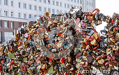 Many castles on the bridge as a symbol of love and friendship. The tradition of lovers. Installation in the city on a Editorial Stock Photo