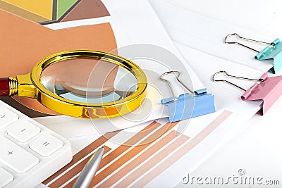 Many charts and magnifying glass. Business concept Stock Photo