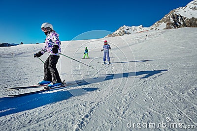 Many children ski on the hill together downhill Stock Photo