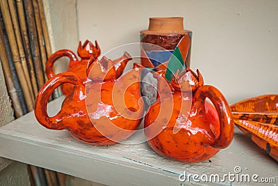 many clay jugs pressed on the shelf for drying. The concept of tableware and a useful hobby Stock Photo