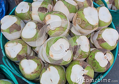 Many coconuts in the basket. Stock Photo