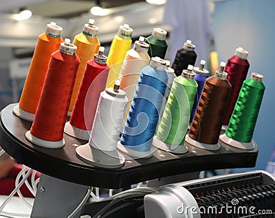 Many coils with colored thread. Clothing industry Stock Photo